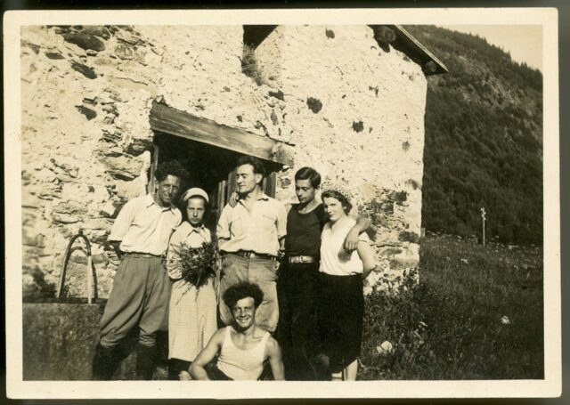 Gruppo di persone davanti ad una cascina in montagna