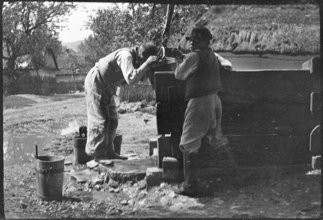 Deux jeunes garçons buvant au puit d'un village slovaque