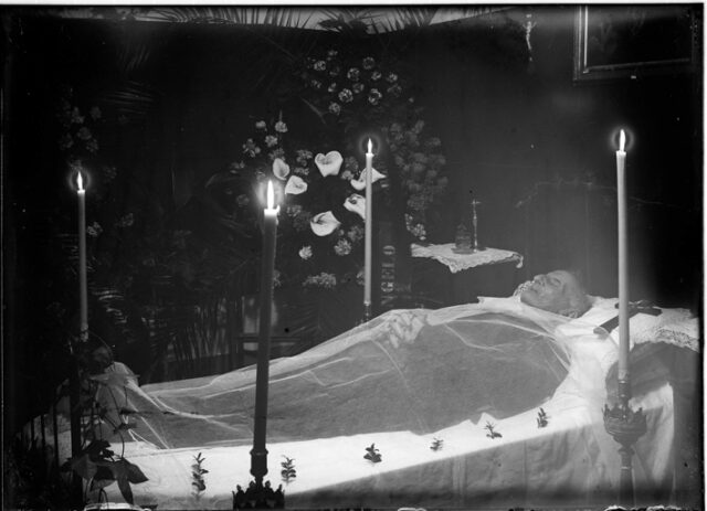 Camera mortuaria con il defunto coperto da un velo