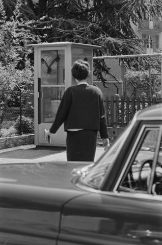Frau bei Telefonkabine