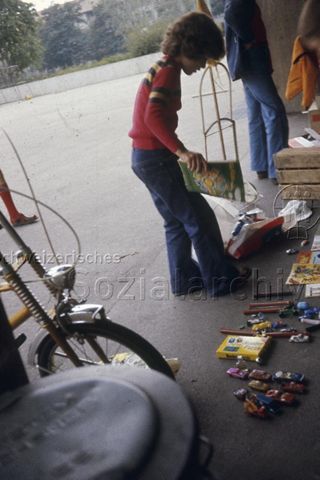 "Spielaktion Schulhaus Vogelsang, Basel" - Junge mit Spielsachen; 1976