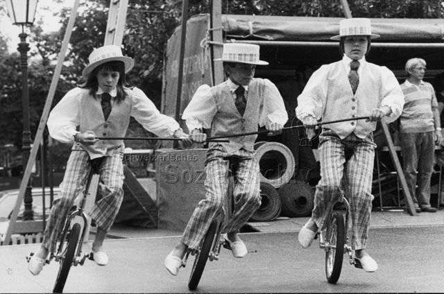 Kinderzirkus Robinson - Drei Kinder beim Aufführen eines Stückes mit Einrädern; um 1975