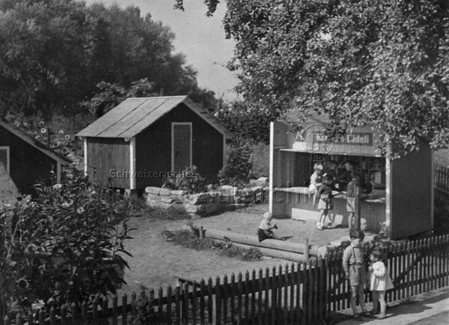 "Kinder-Spieldörfli mit Konsumladen in der Kleinkinder-Ecke des Robinson-Spielplatzes Zürich-Wipkingen"; um 1965