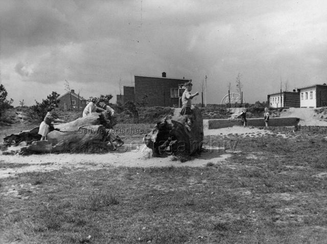 "Harlow Development Corporation, Children at aply in Area 1, Glebelands, Adventure playground, Mark Hall North - This was the first playground provided by the Corporation (...)"; 1954